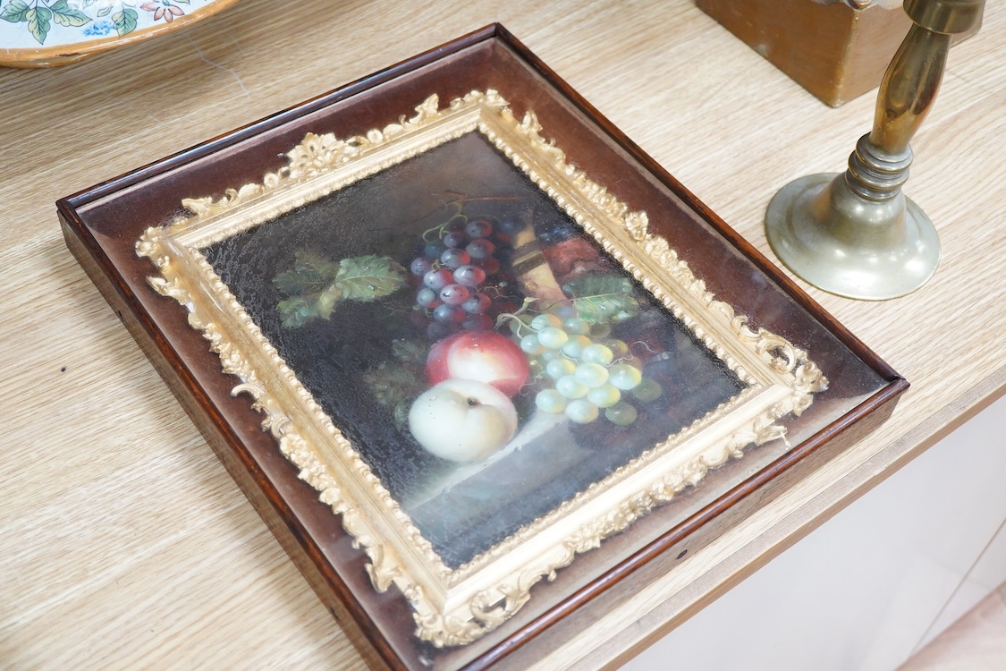 A painted porcelain plaque, still life of fruit, housed in an ornate gilt frame, overall 35 x 30cm